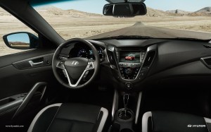 Veloster's interior looks great, with an efficient steering wheel hub full of buttons and a good video screan mid-dash.