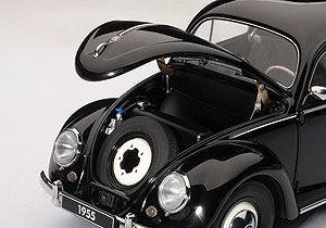 Under the hood, simply a spare tire. Hinges are well executed to hold the hood up for display.