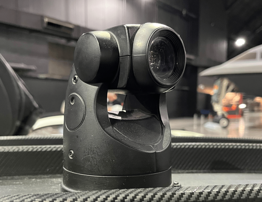 Close-up of a Forward Looking Infrared (FLIR) camera system used in the Vapor Supercar, showcasing high-tech surveillance capabilities.