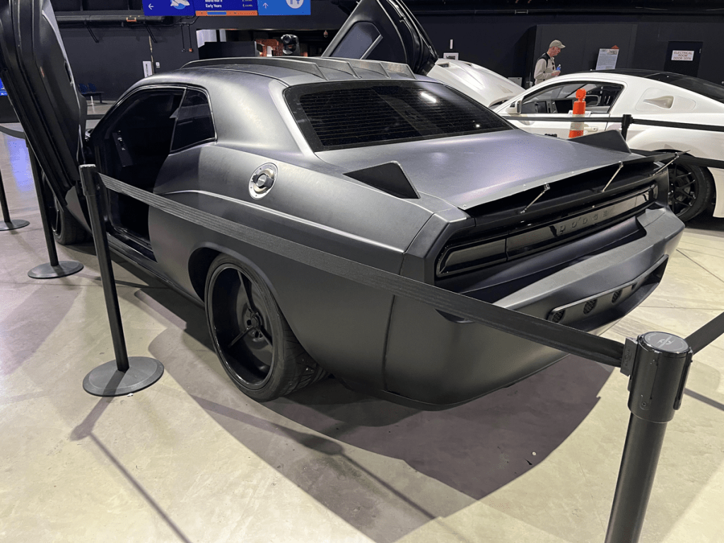 A customized Dodge Challenger, the Vapor Special Operations Supercar, displayed at the National Museum of the US Air Force with gull-wing doors open and a stealthy matte finish.