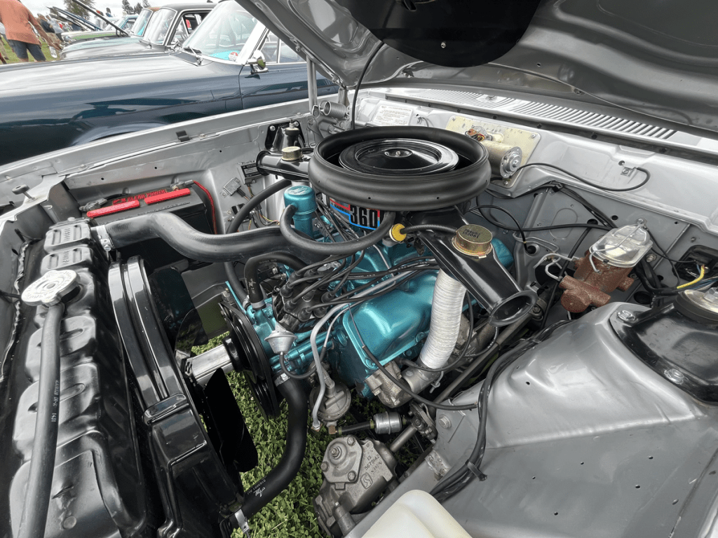 Close-up view of the engine bay of a 1972 AMC Hornet SC/360, featuring the 360 V8 engine and various engine components.