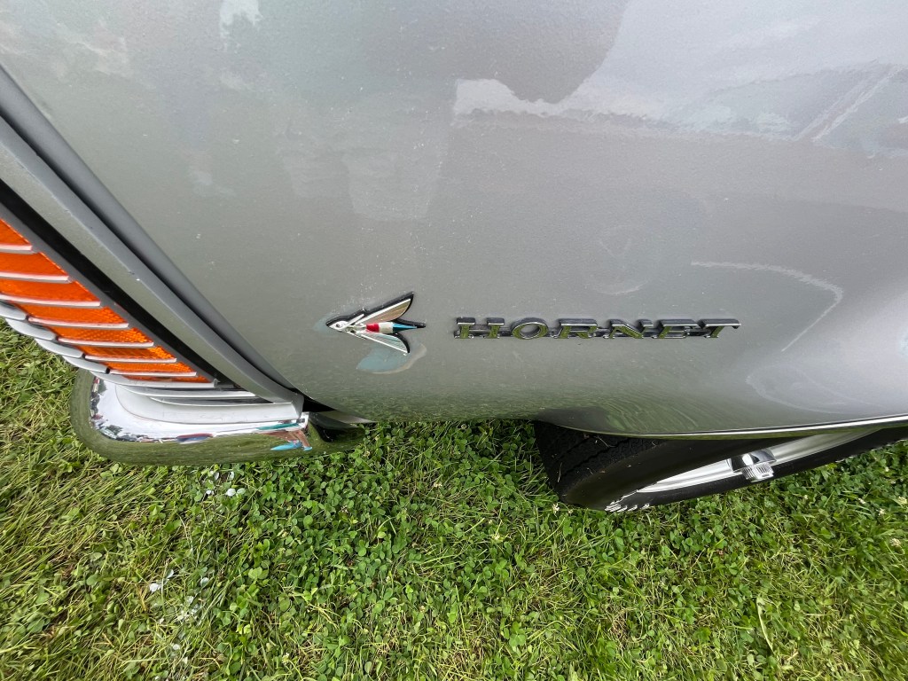 Close-up of the 1971 AMC Hornet SC 360 logo on the rear fender, showcasing the distinctive design and detailing.
