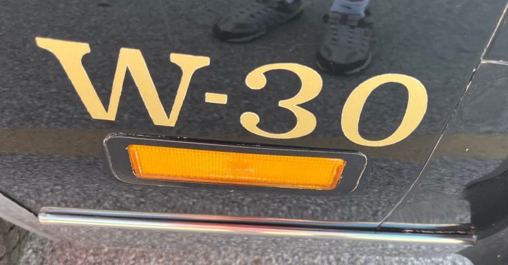 Close-up of a 79 Hurst/Olds' side showing the gold lettering 'W-30' and an orange reflector light.
