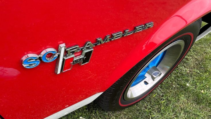 Car Spot: 1969 AMC Hurst SC/Rambler side logo and blue slotted wheels.