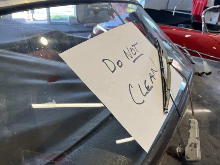 A paper sign with the words 'Do NOT Clean' placed on the windshield of  Rare 1958 Porsche Speedster in Green Bay